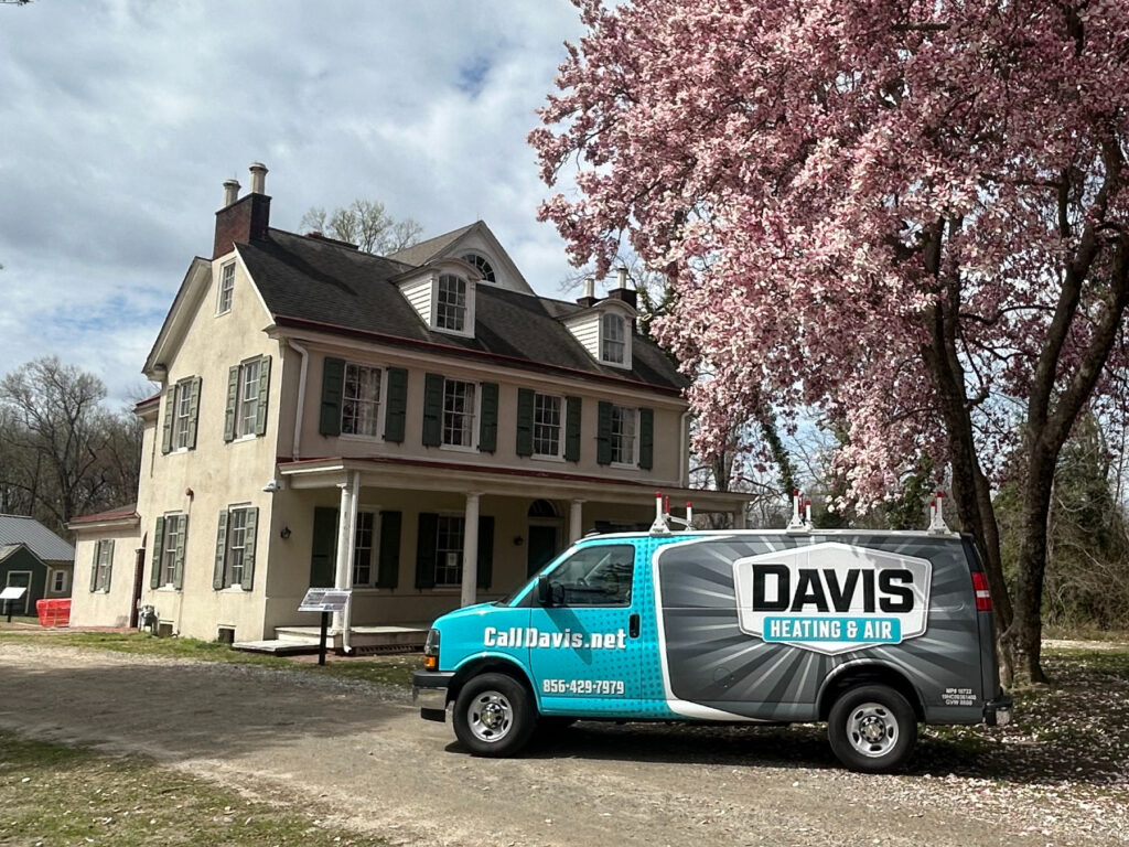 a Davis Heating and Air branded vehicle parked in front of a home in Cherry Hill about to receive maintenance with the Davis Comfort Elite plan